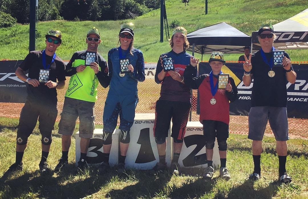 Pro riders celebrating on the podium at awards